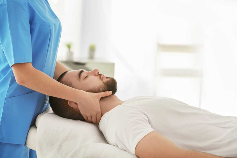Parent and child speaking with a clinician during a gentle musculoskeletal examination.